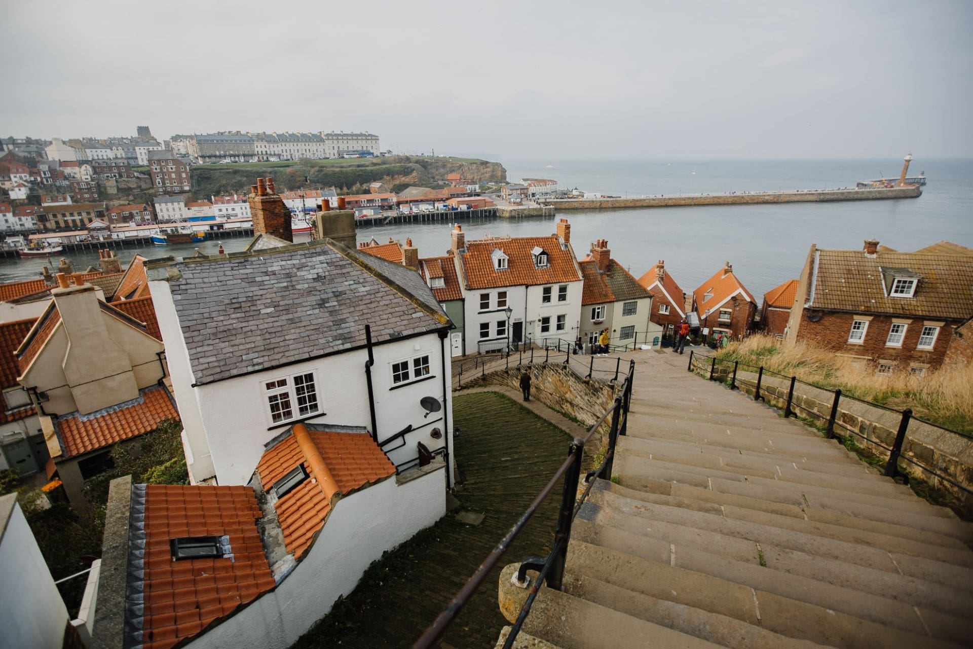 steps-leading-down-to-harbour-in-cute-british-seaside-town-whitby-robin-hoods-bay-day-trips-from-leeds-england-uk